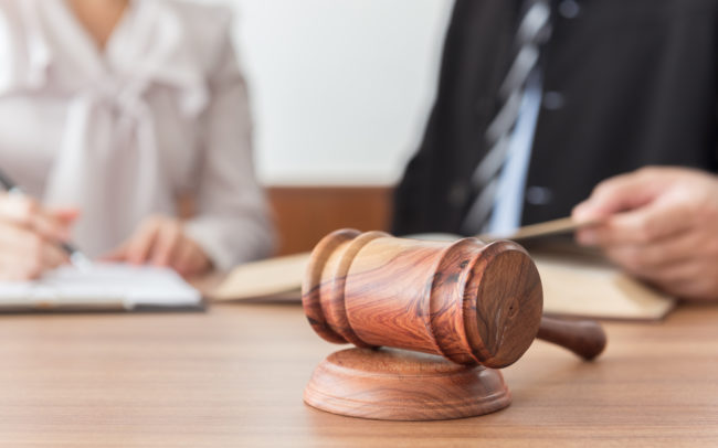 Judge gavel with lawyer and attorney meeting in law firm background. Concepts of law, legal advice,legal services.