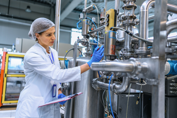 Female engineer working on maintenance in bottling plant