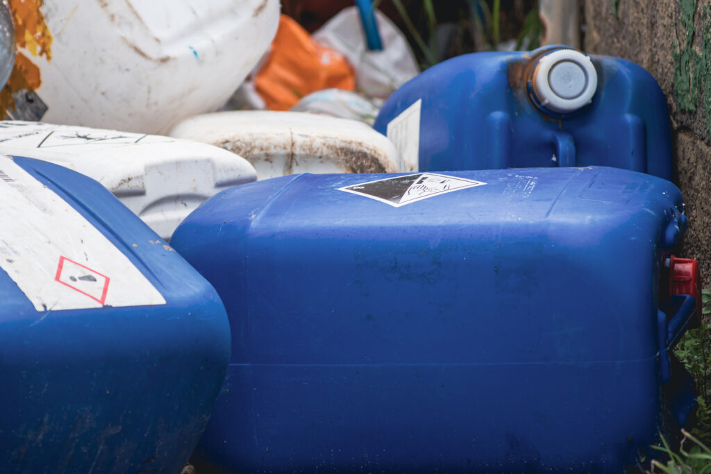 Chemical container for toxic liquid, warning symbol in bio hazard dangerous blue tank. Recyclabe plastic waste barrel. Recycle for climate change concept.