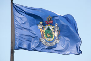 Maine State Flag in Blue Sky