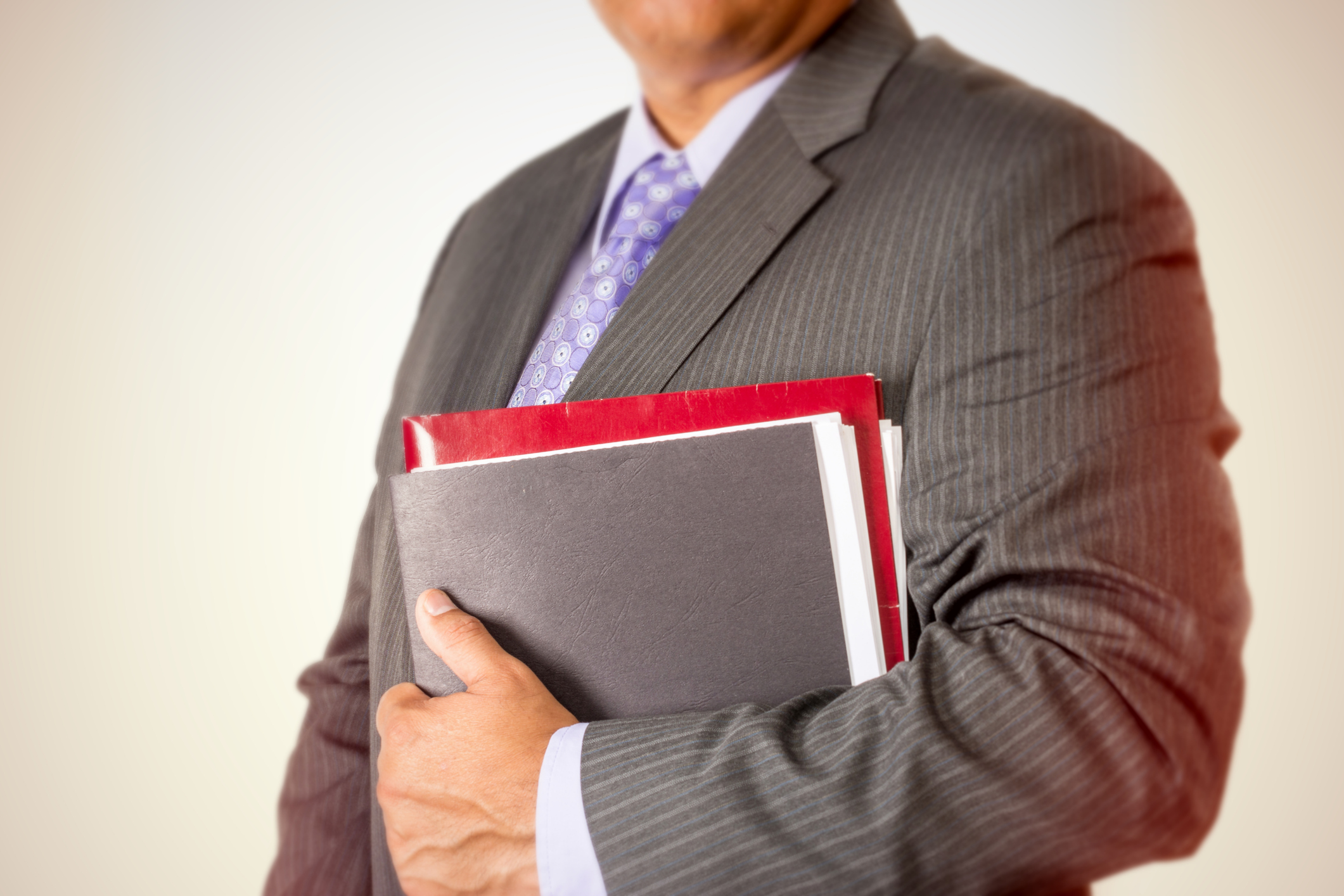 Businessman holding files against his suit