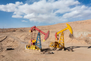Close-up of pumping unit in mountainous oil field