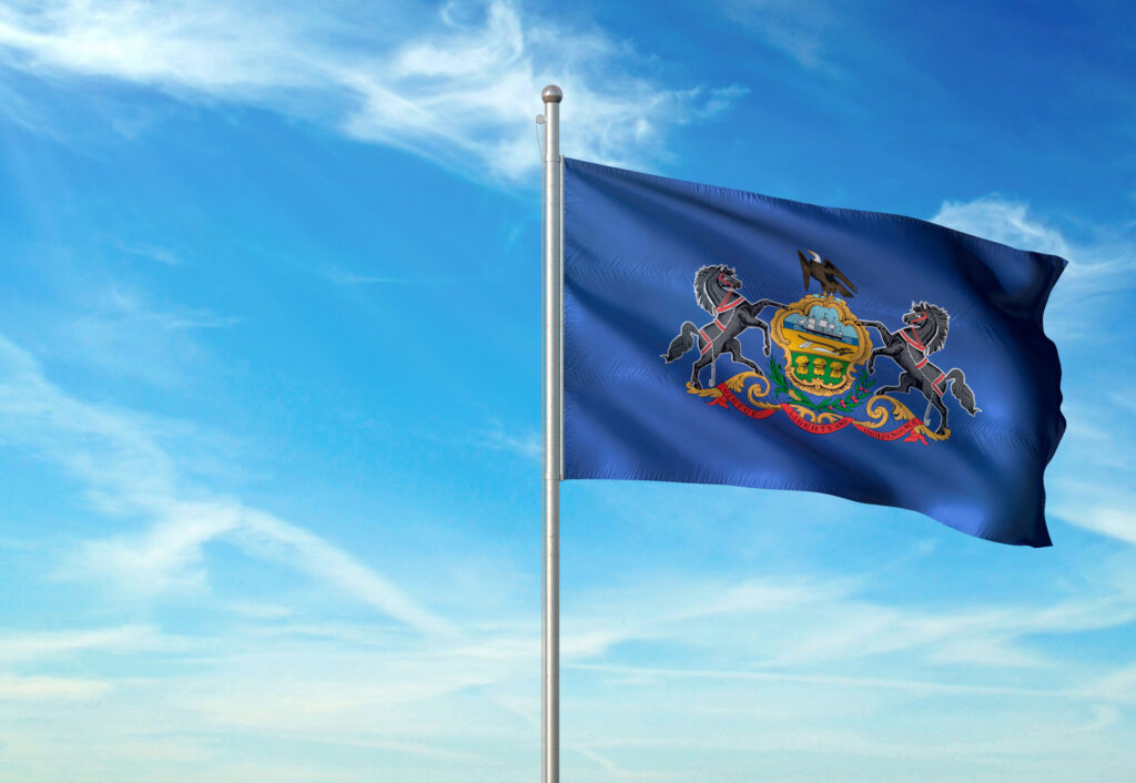 Pennsylvania state of United States flag waving cloudy sky background