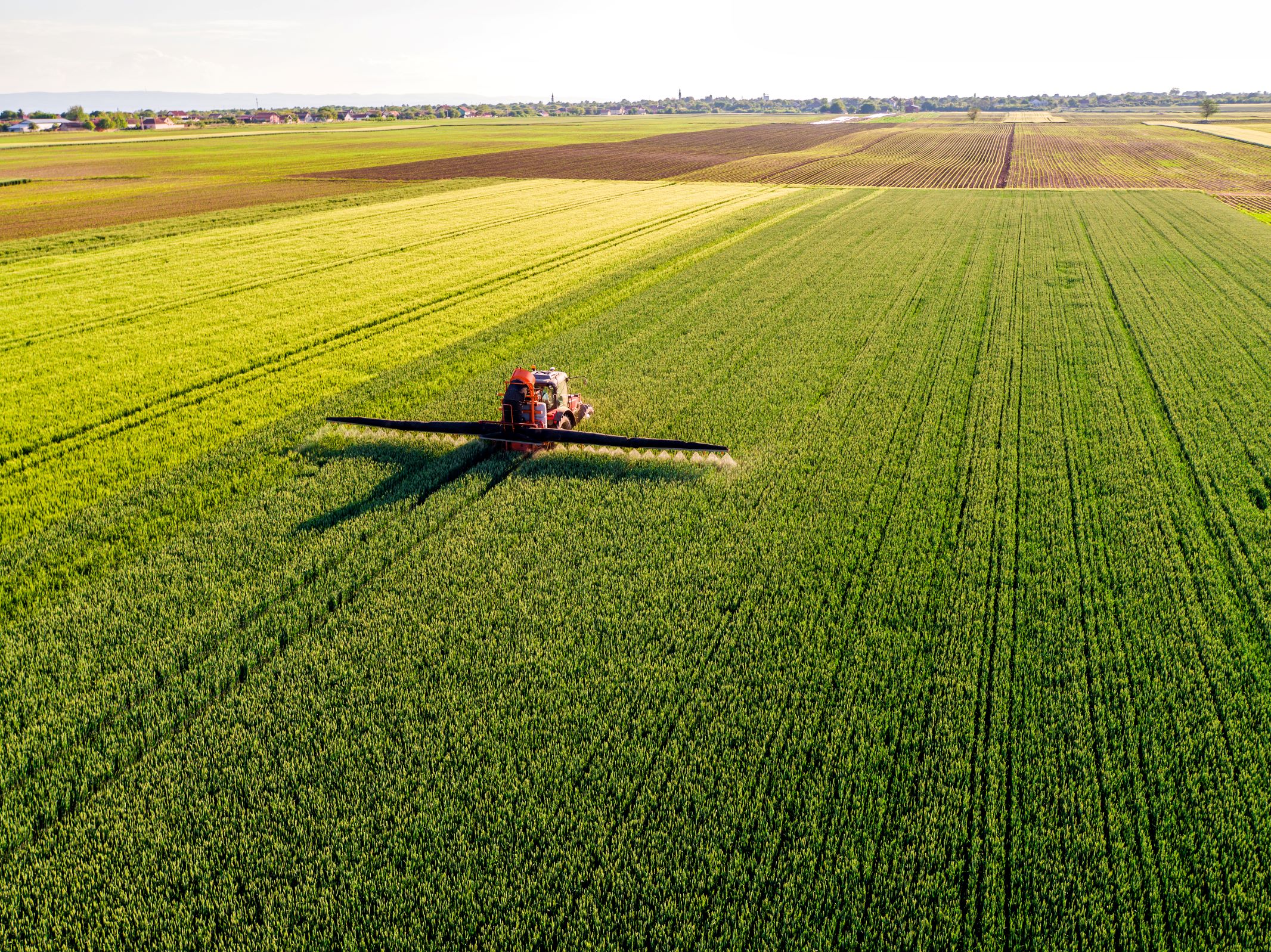 Tractor spraying crops