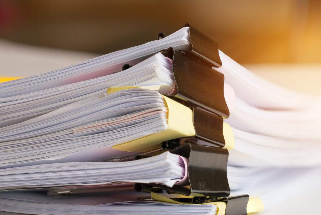 Stack of Paper documents with clip, Pile of unfinished documents on office desk folders.