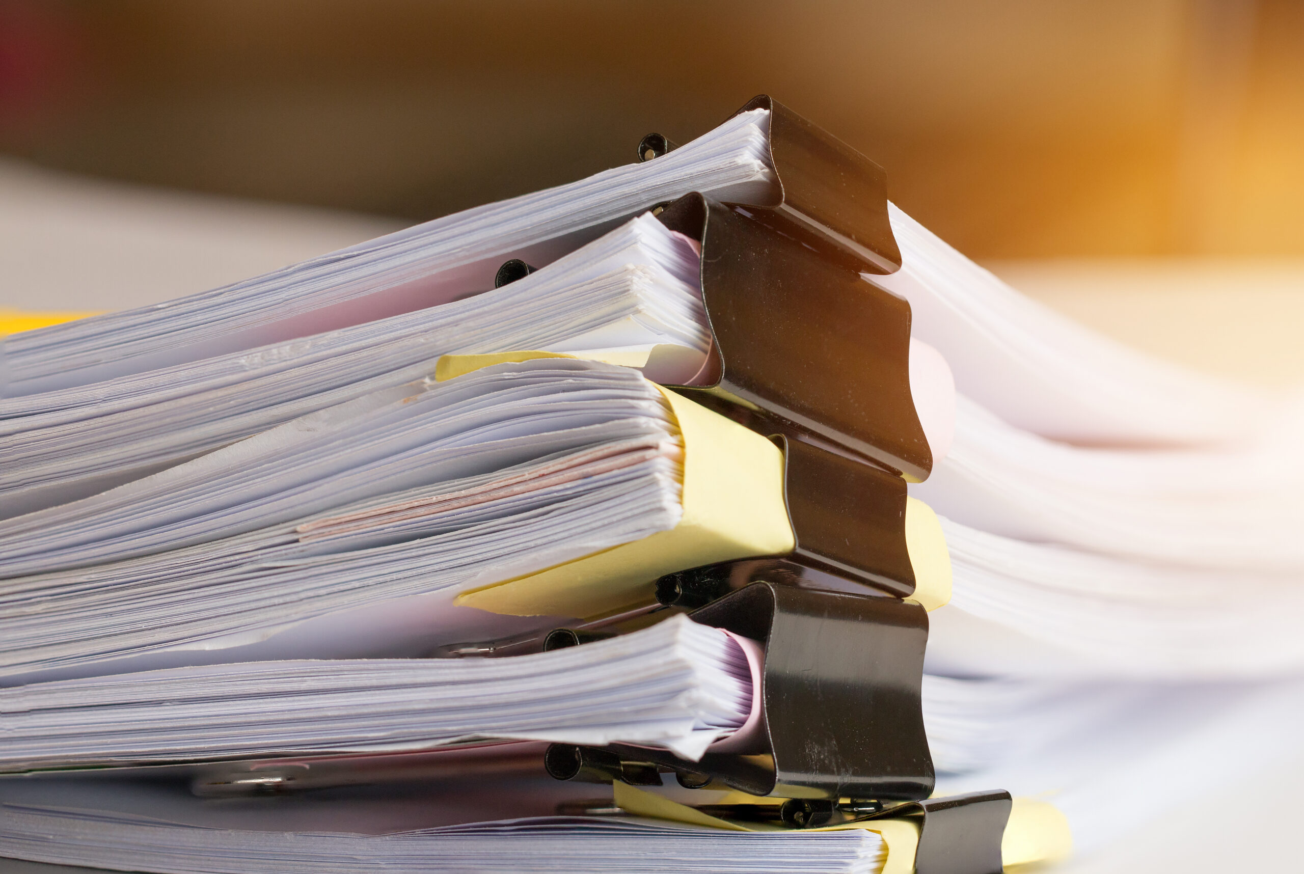 Stack of Paper documents with clip, Pile of unfinished documents on office desk folders.