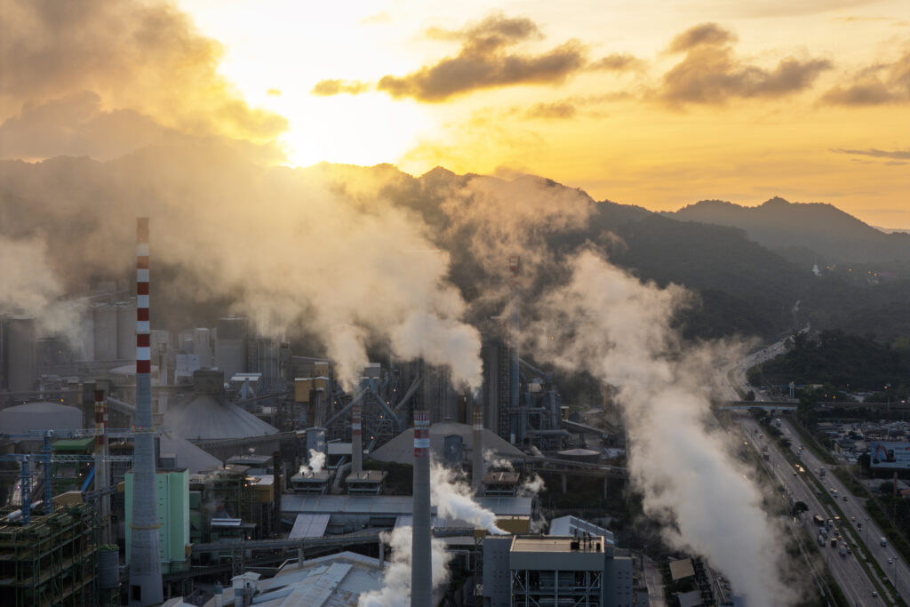 Industrial Factory Emitting Smoke During Golden Sunset