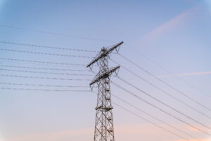 Electricity pylon against pastel sky