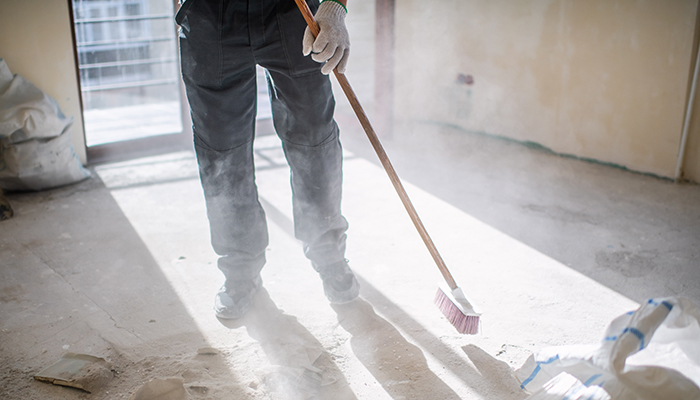 Worker cleaning construction site during home renovation